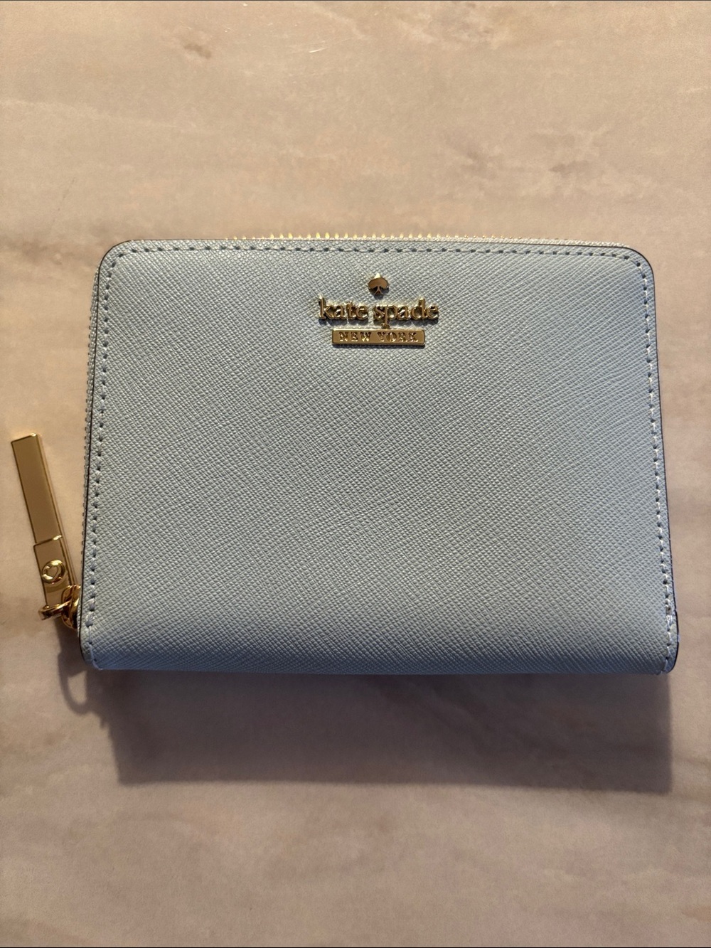 kate spade pastel blue zip-around compact wallet with gold logo